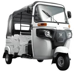 White Bajaj RE tuk tuk with doors photographed from the front three-quarter angle